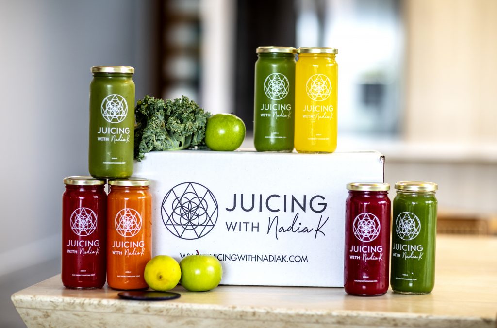 Juicing with Nadia K's Fresh Juices displayed on bench top next to branded box