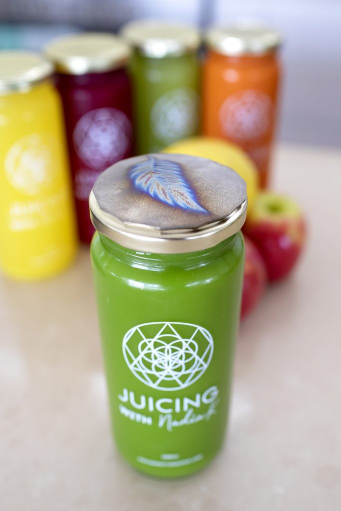 Close up of green juice with Tesla Plate on lid